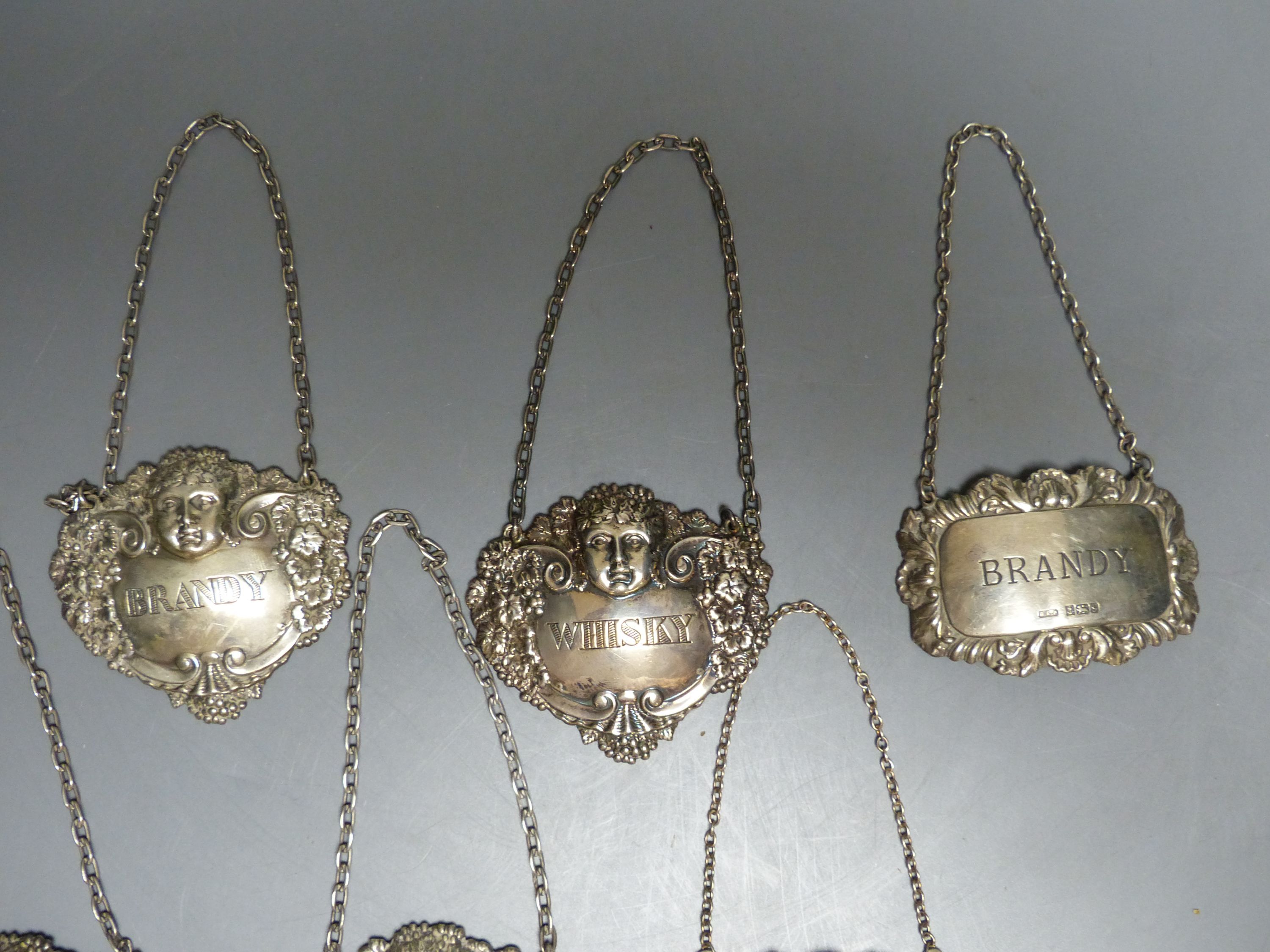 Six assorted modern silver decanter labels, gross 98 grams,